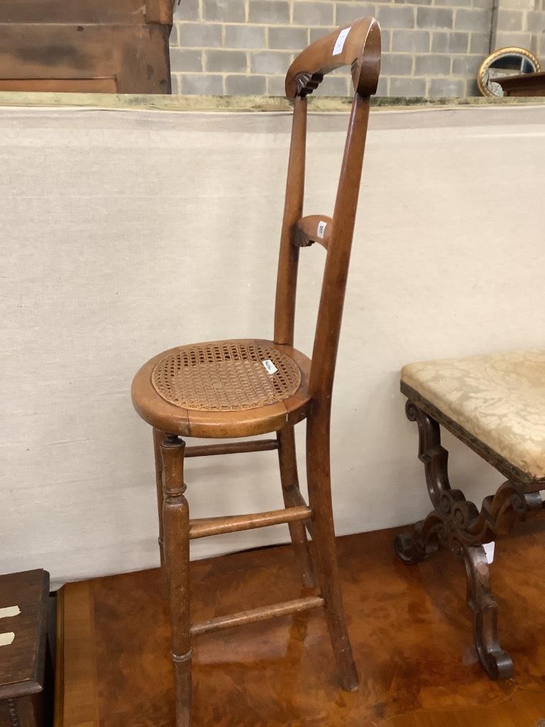 A Victorian beech caned seated correction chair, height 96cm